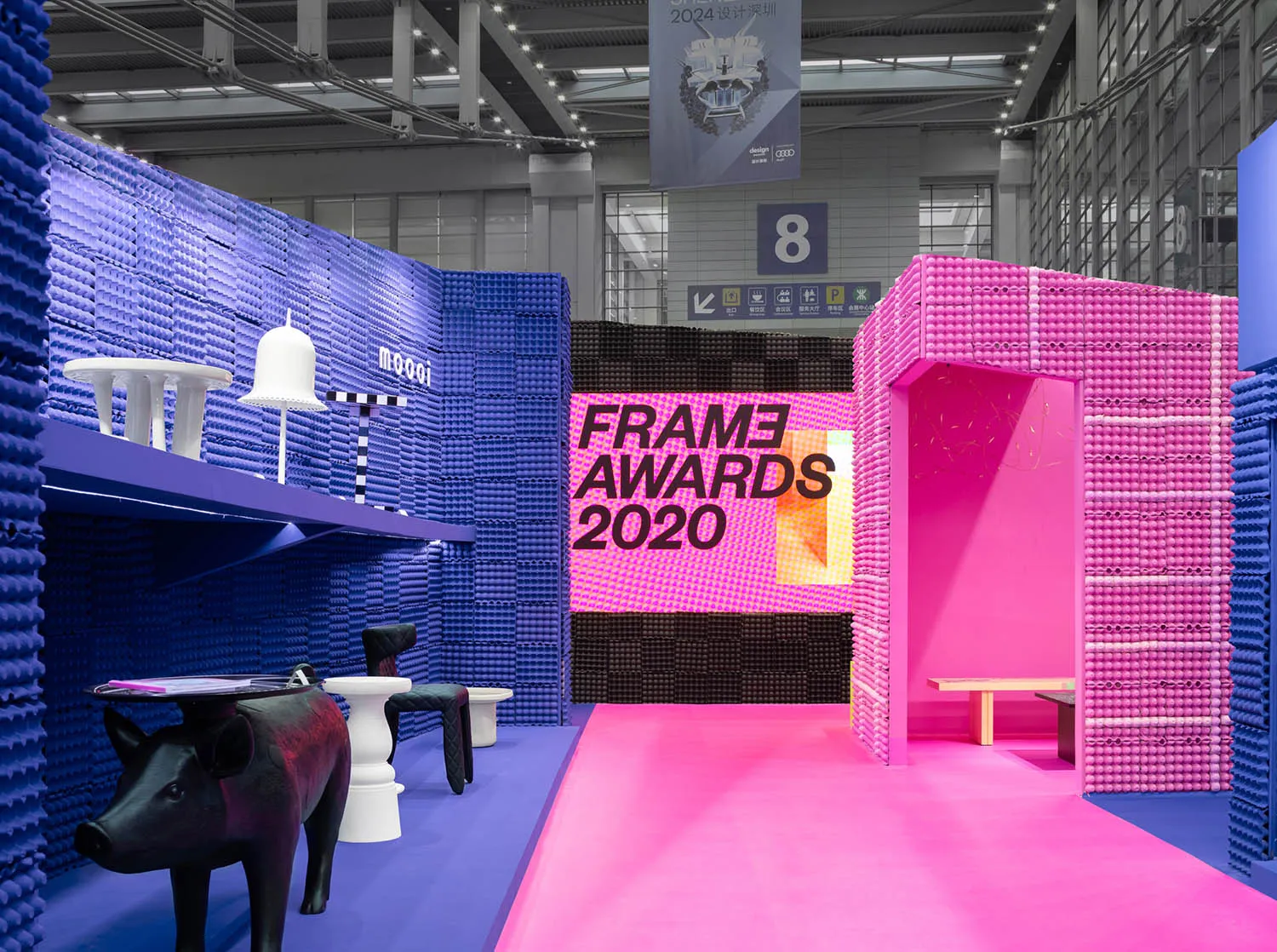 An exhibition space with minimalist design featuring plastic bricks.