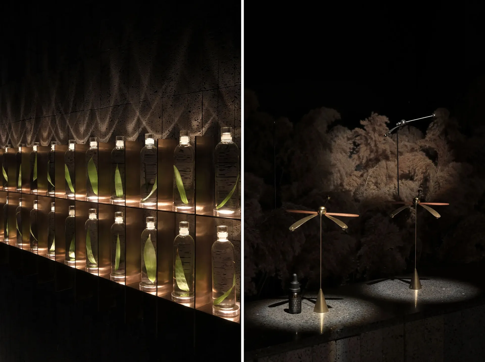 Multiple glass bottles arranged in a dark room, illuminated by warm lighting, showcasing a modern retail space design.
