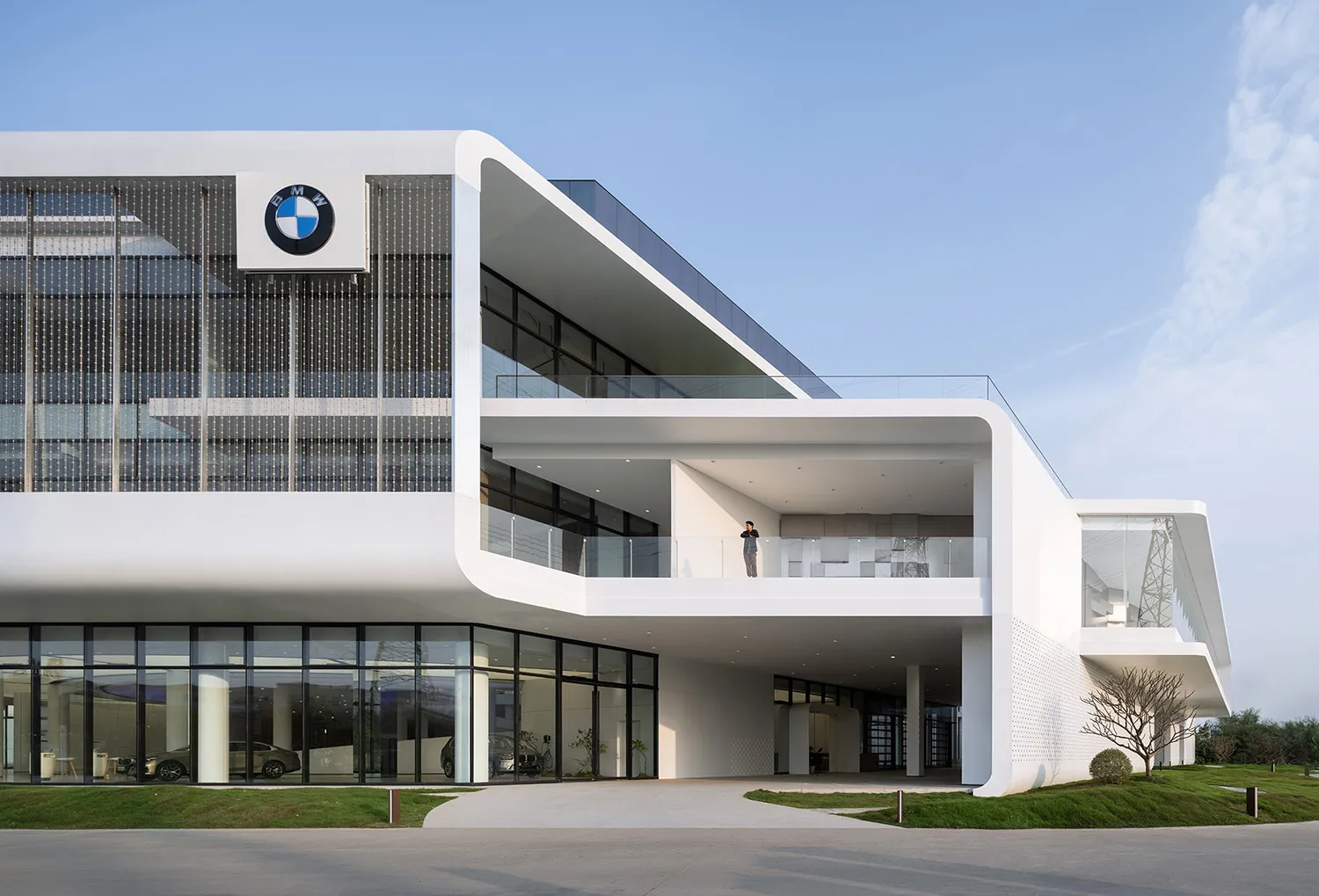 Modern, minimalist commercial building with glass and concrete materials.