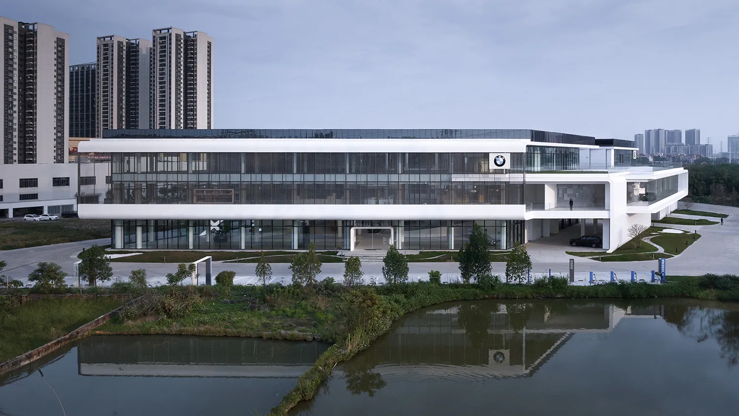 A modern building featuring concrete and glass materials with a minimalist design.
