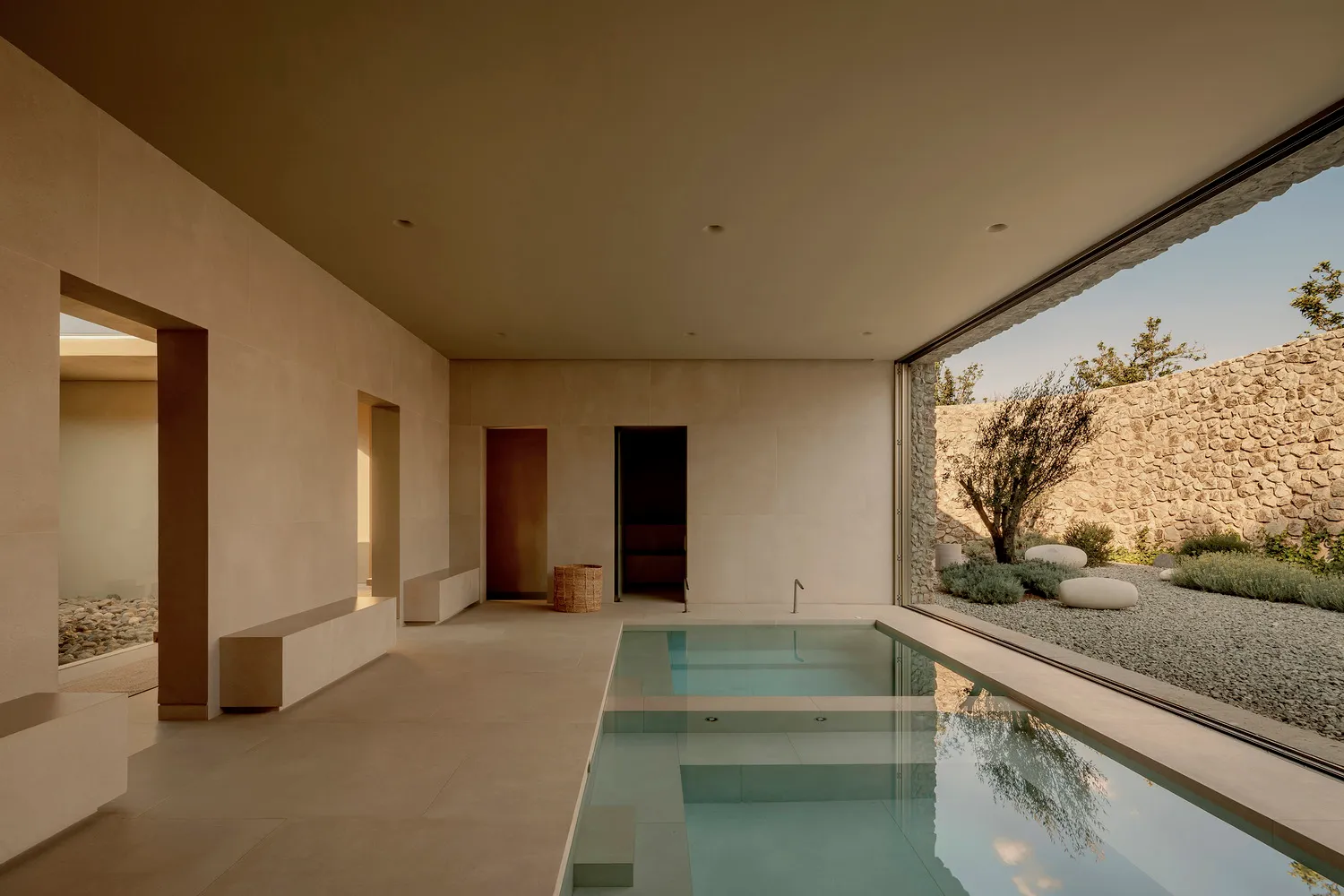 Modern minimalist residential swimming pool constructed from concrete and glass.