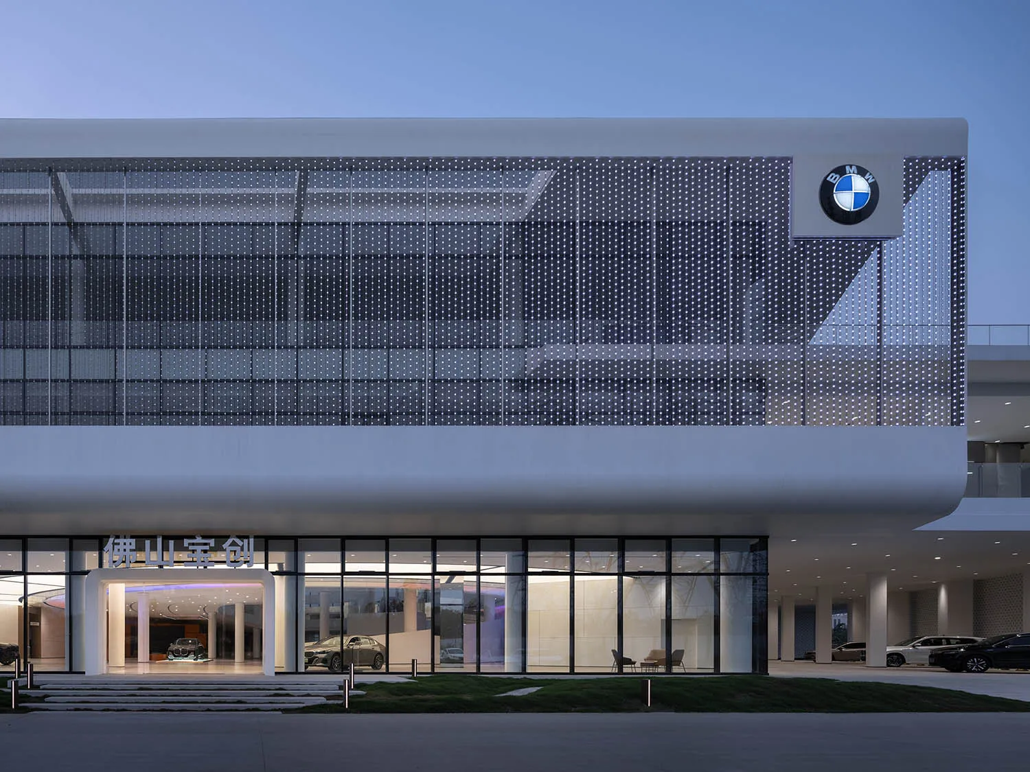 A modern BMW commercial building exterior with glass and metallic surfaces.