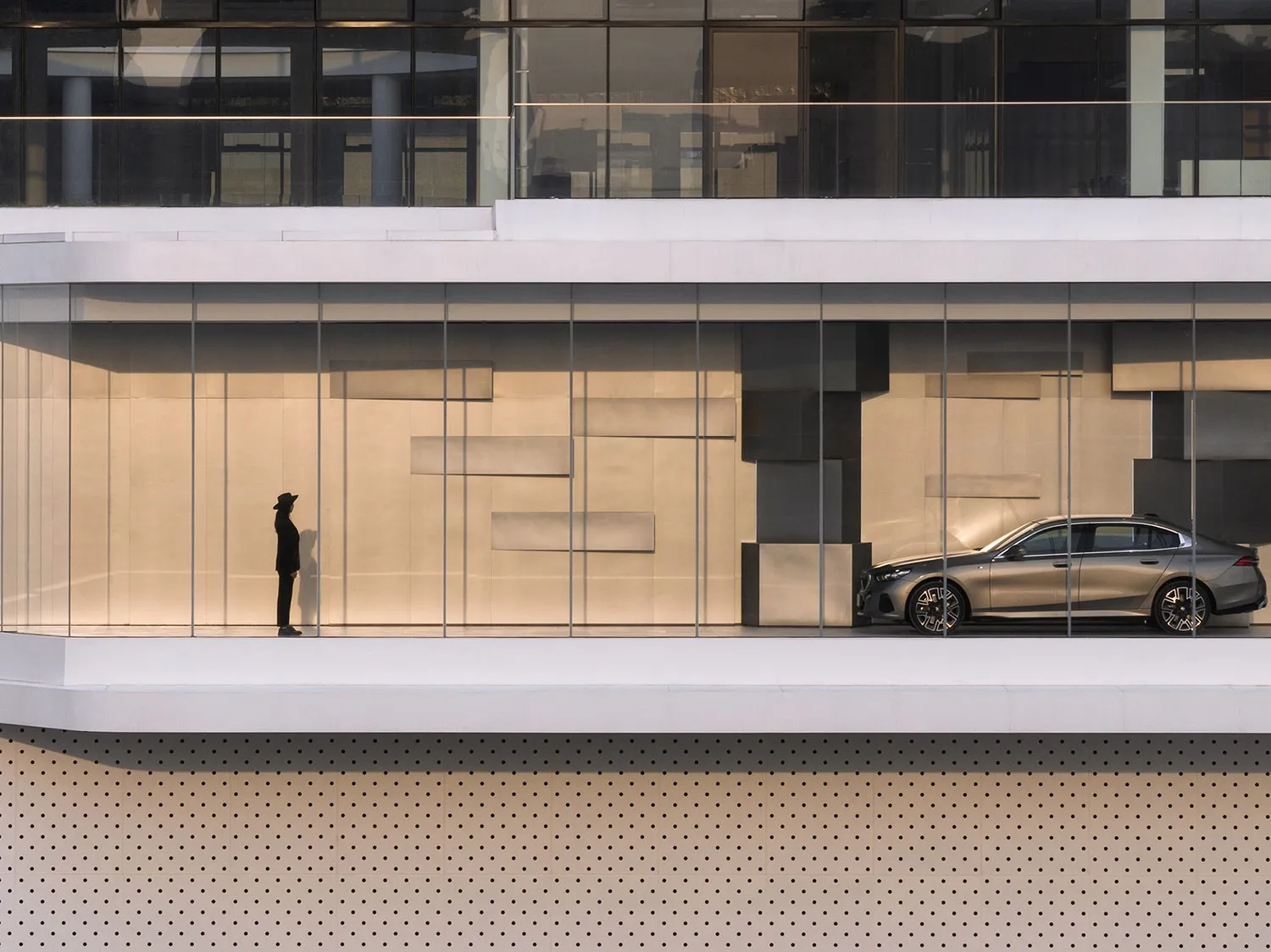 Modern architectural design featuring glass walls and interior elements.