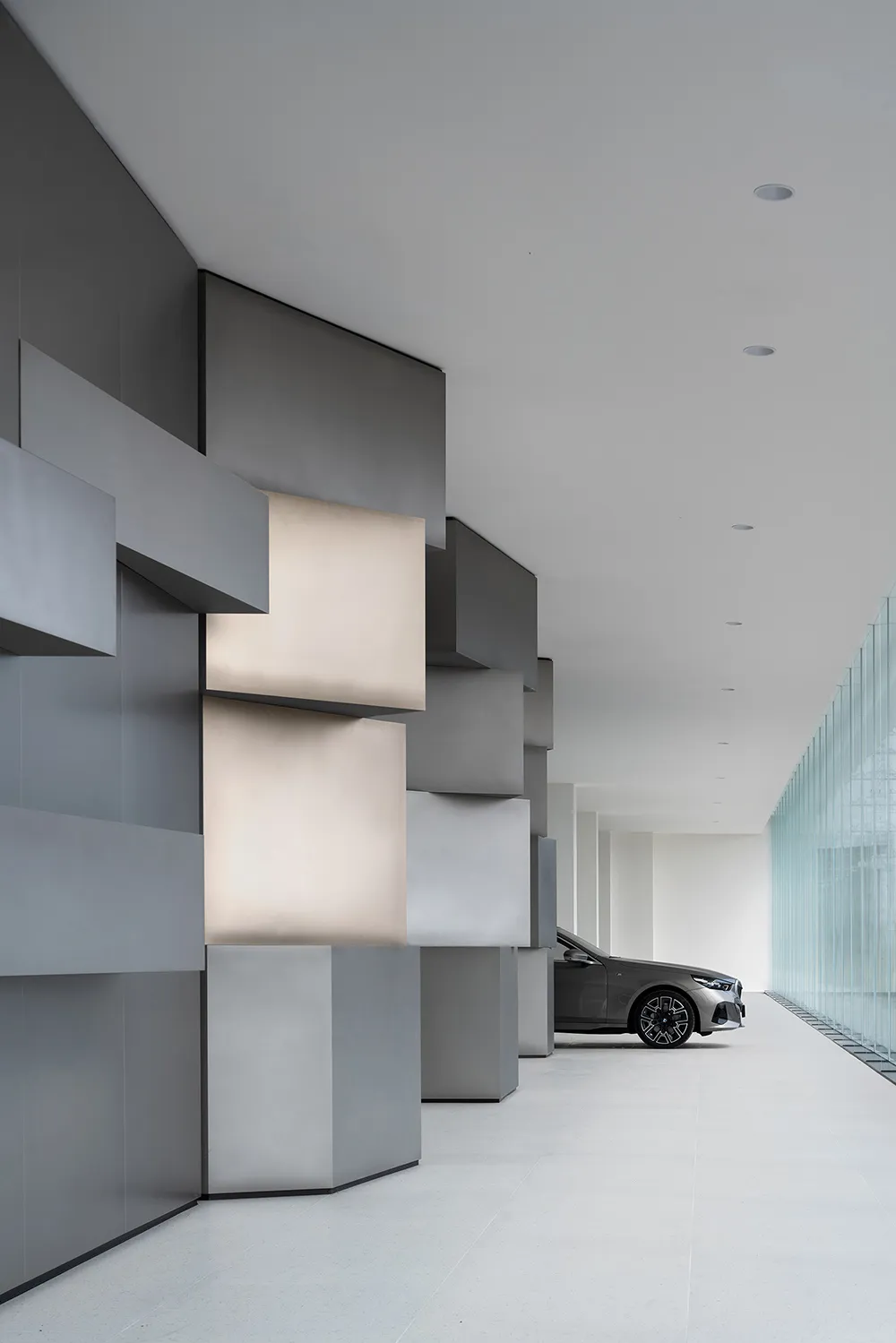 Modern interior with metallic panels and geometric lighting fixtures.