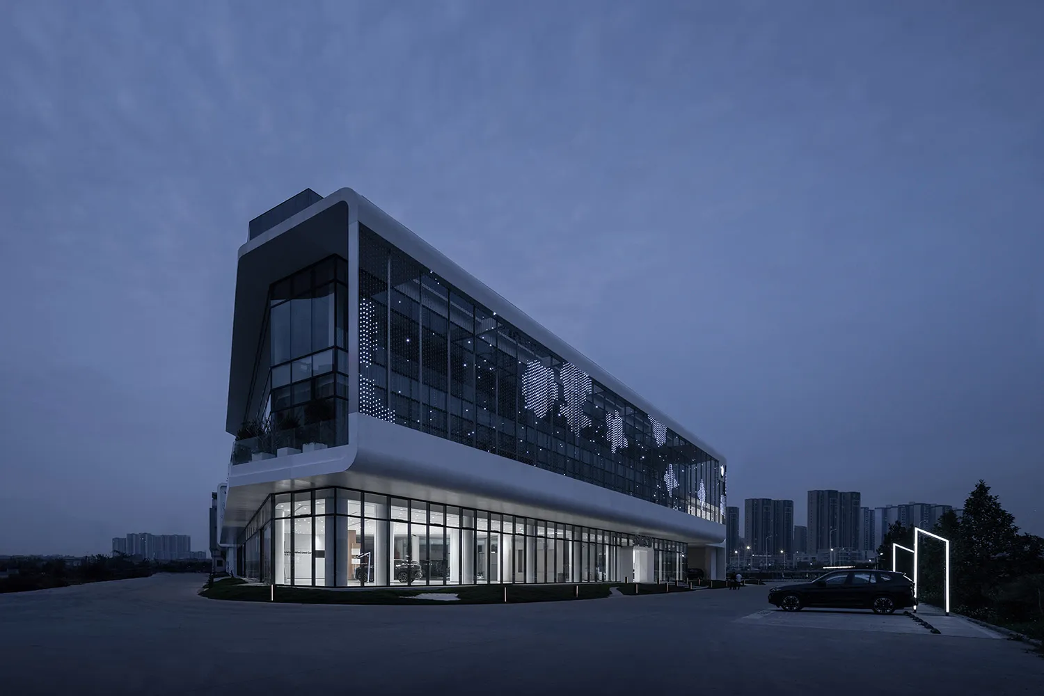 A modern office building with glass walls and concrete accents.