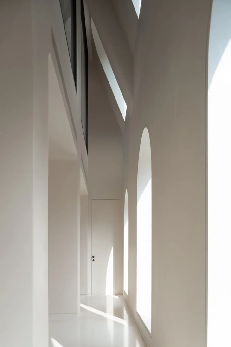 Minimalist space with white interiors, showing clean lines and open design.