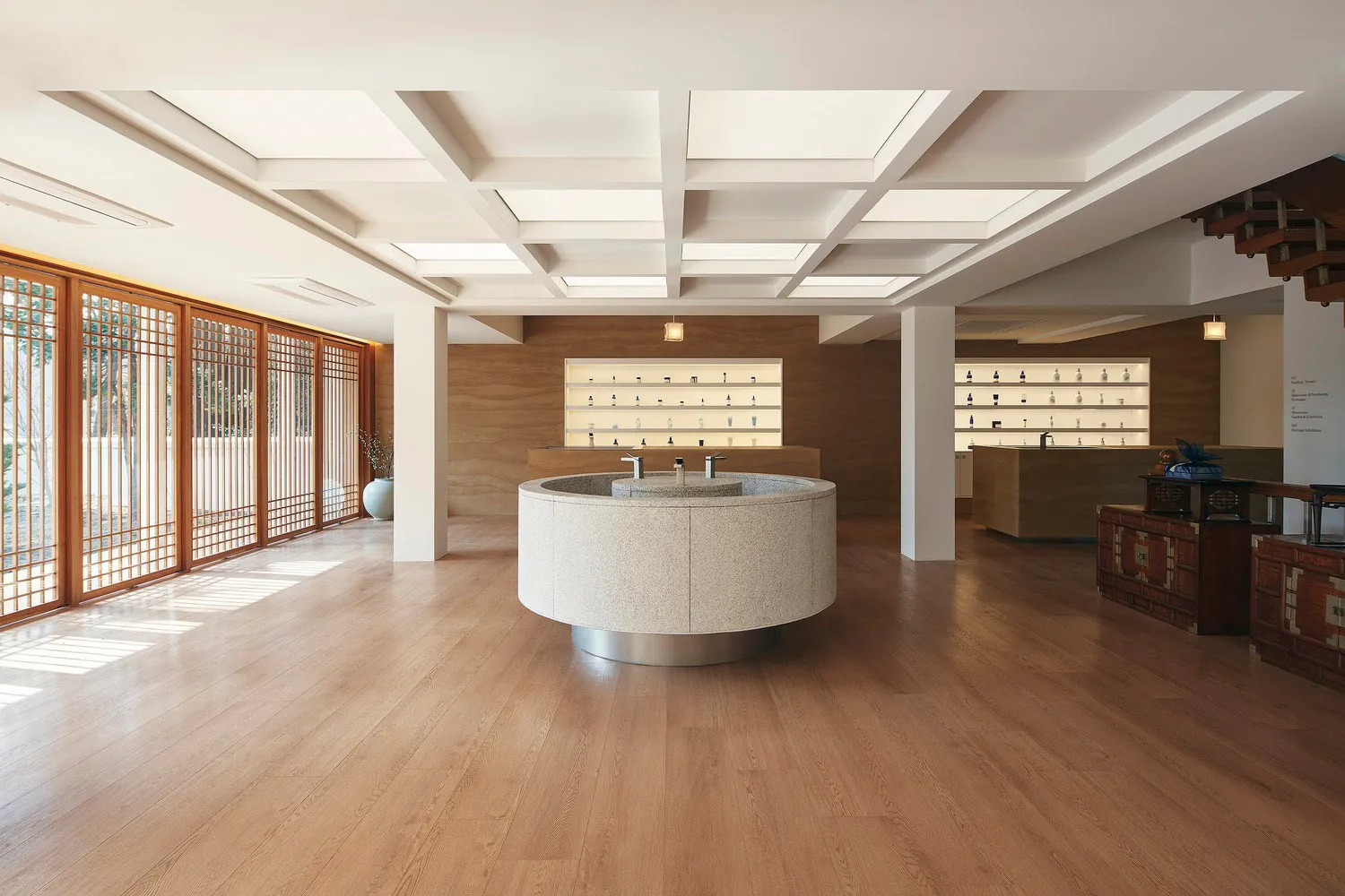 Spa interior with modern design elements, featuring stone basin and wooden flooring.