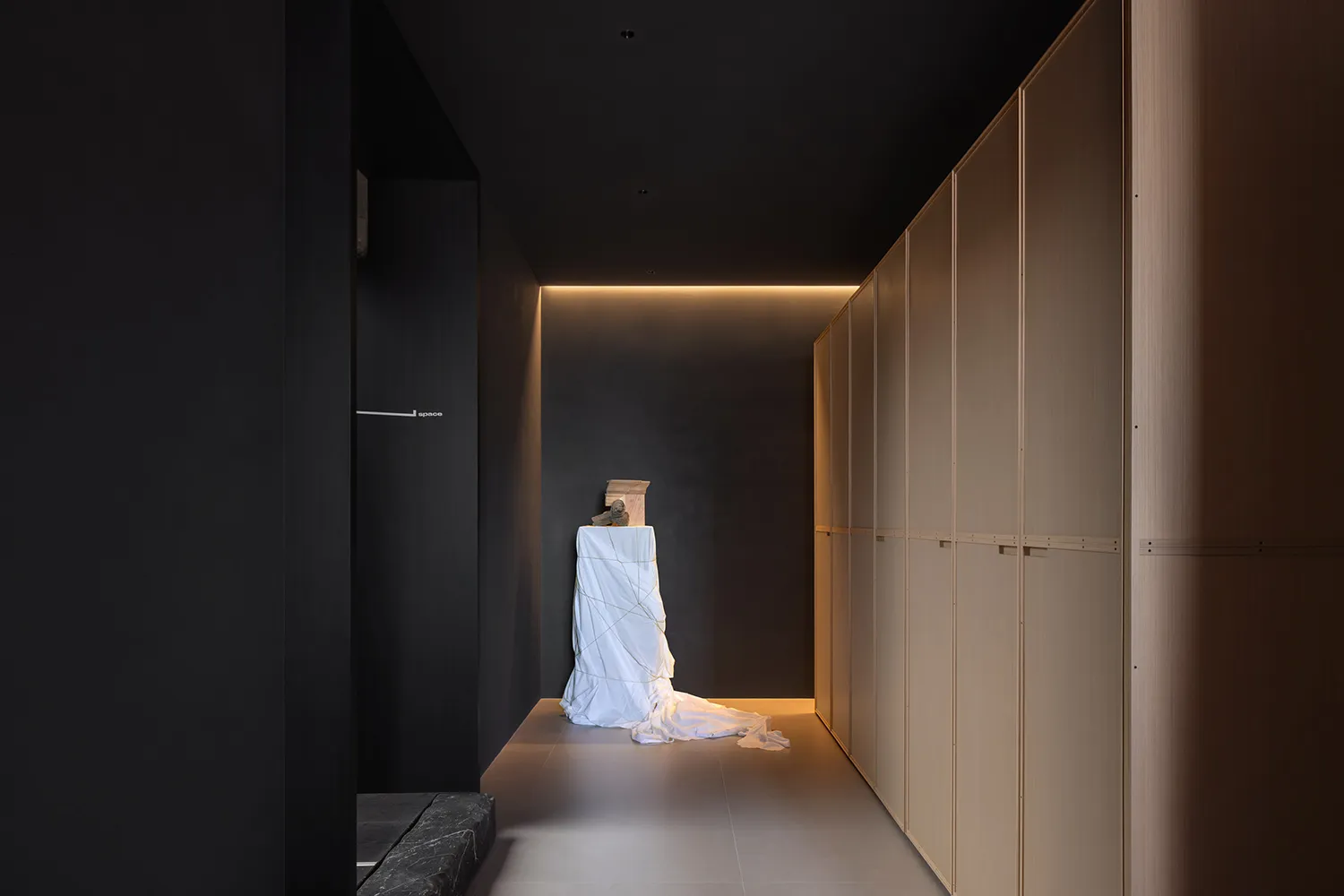 Minimalist interior with wooden and stone elements.