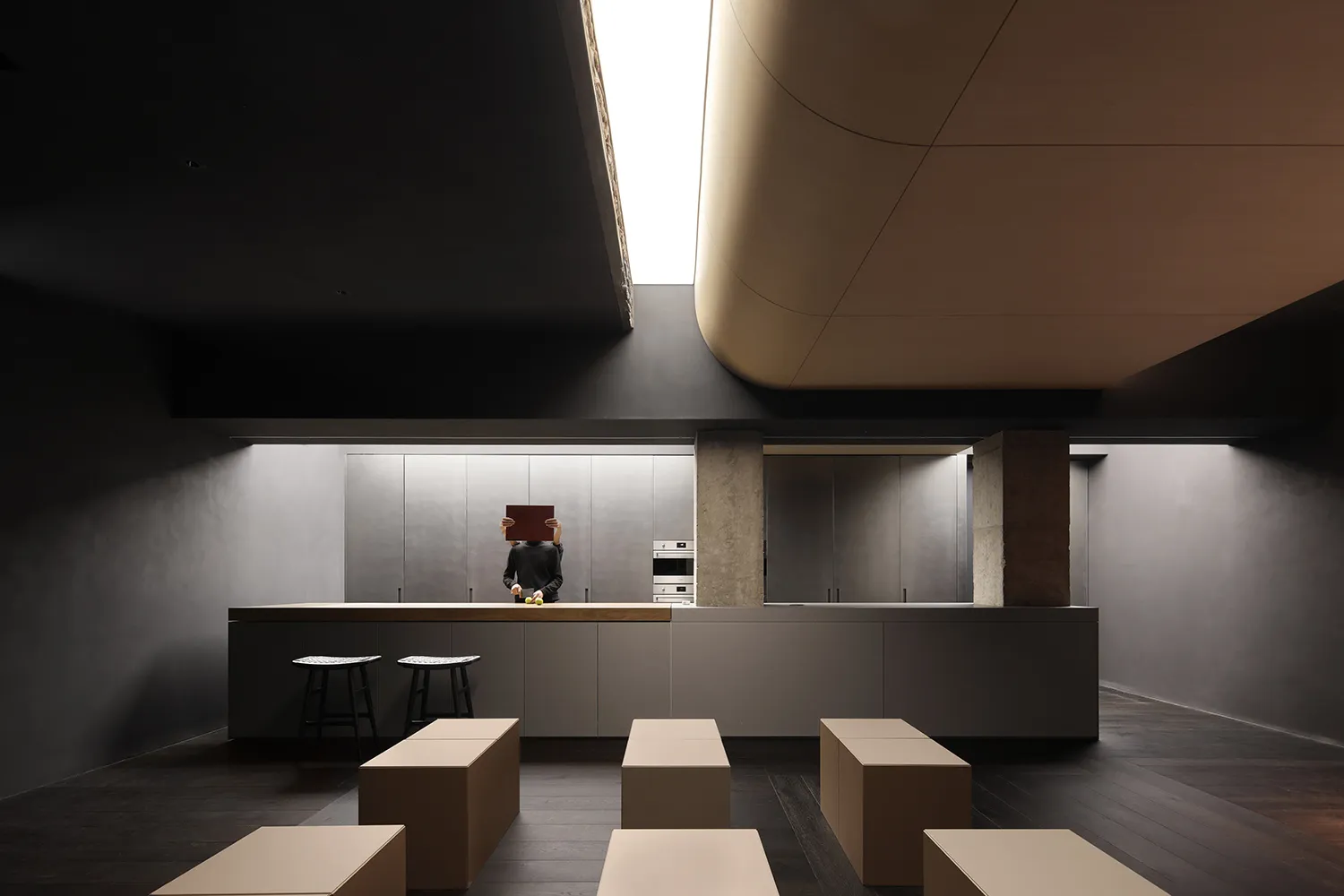 Modern living area with concrete walls and minimalist furniture.