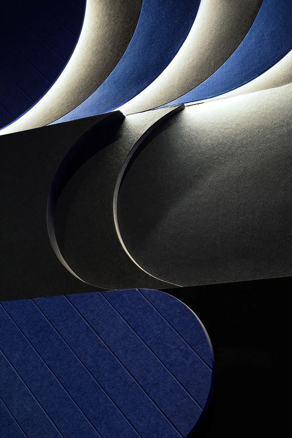 A section of modern architecture with metal textures and sleek, curved lines.
