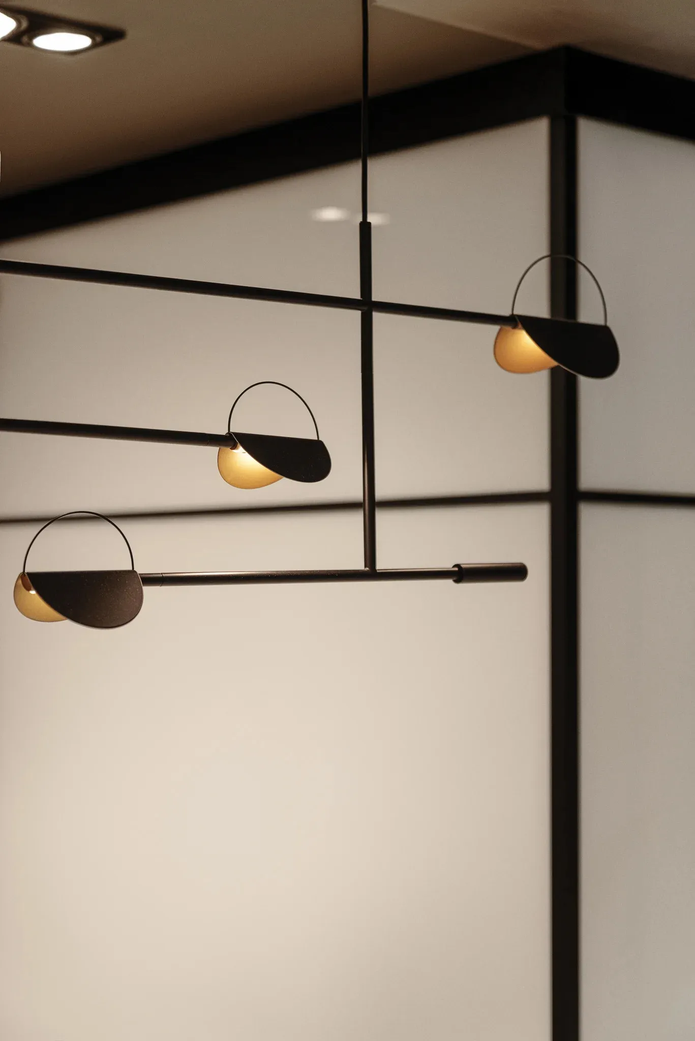 Modern industrial hanging lights with steel material hanging from the ceiling.