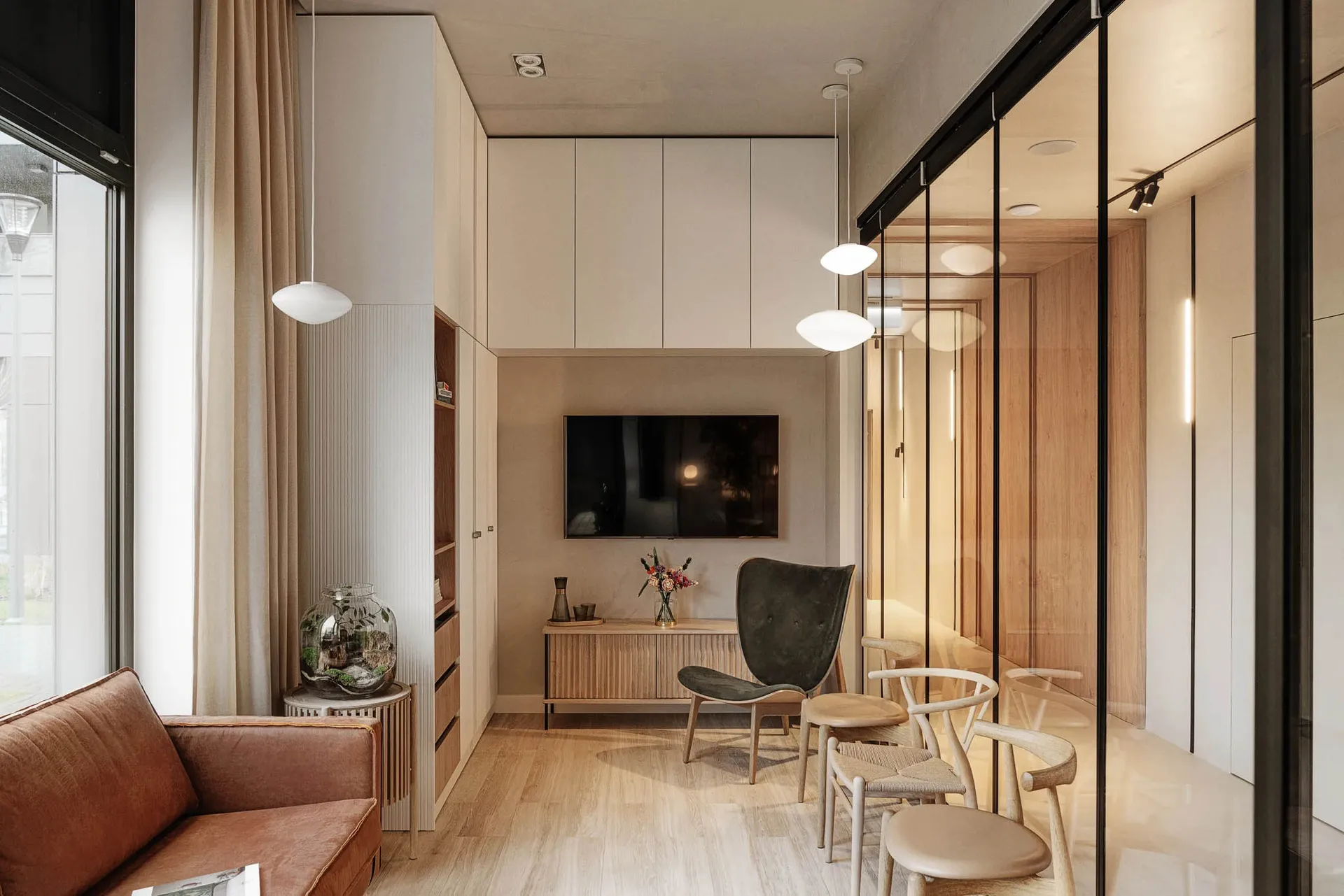 A modern living room with minimalist design, featuring wood flooring and furniture.