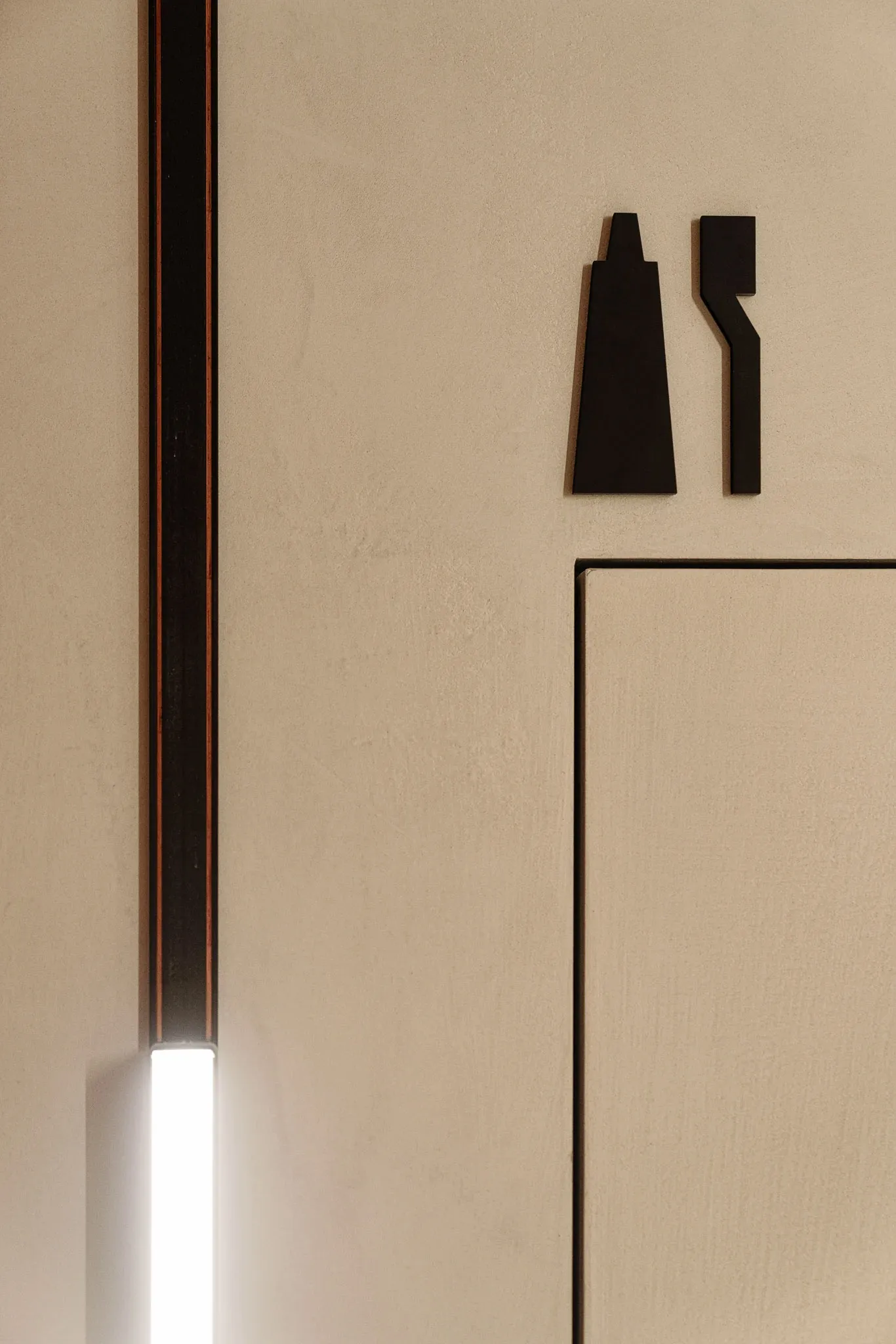 Simple, geometric door signs made of metal.