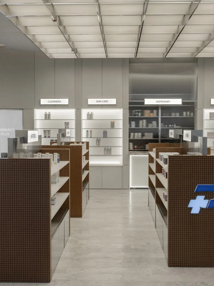 A modern pharmacy storefront with glass walls and interior design