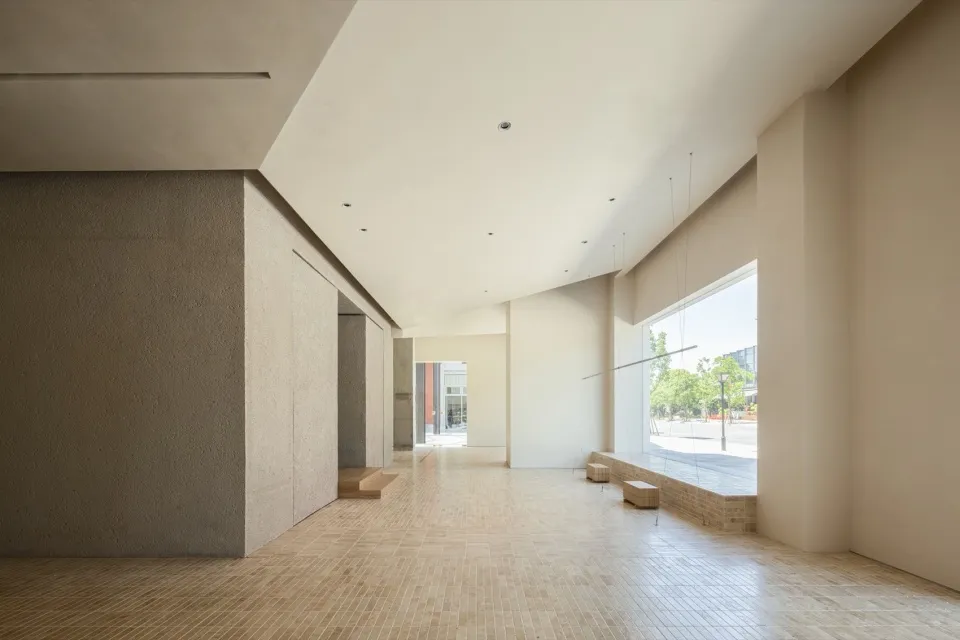 Modern minimalist lobby featuring smooth, concrete walls and flooring.