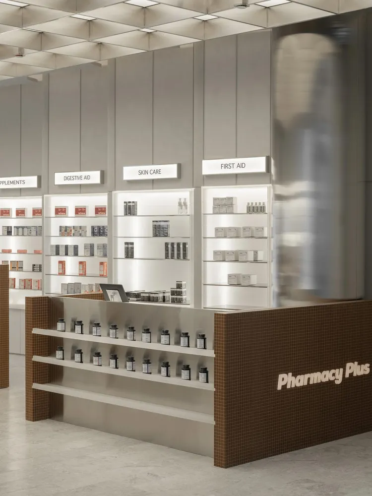 A modern pharmacy interior with concrete finishes and illuminated product shelves.