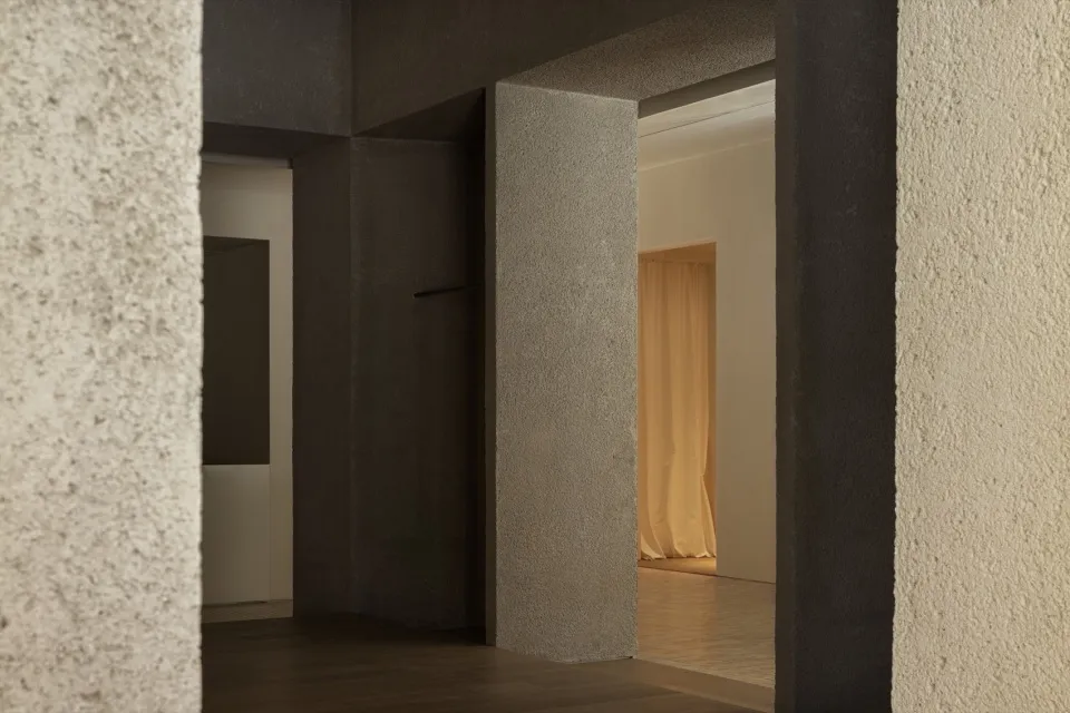 Modern minimalist interior with concrete walls and floor.