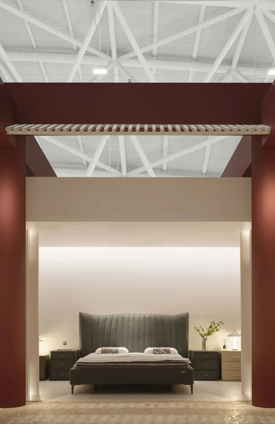 Modern minimalist bedroom with neutral tones and soft lighting, featuring a wooden headboard and soft mattress.