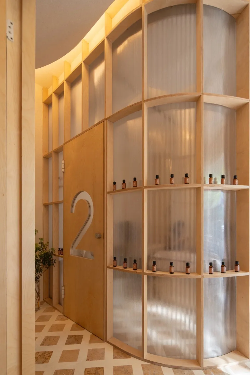 A spa interior featuring a wooden shelf with small bottles.