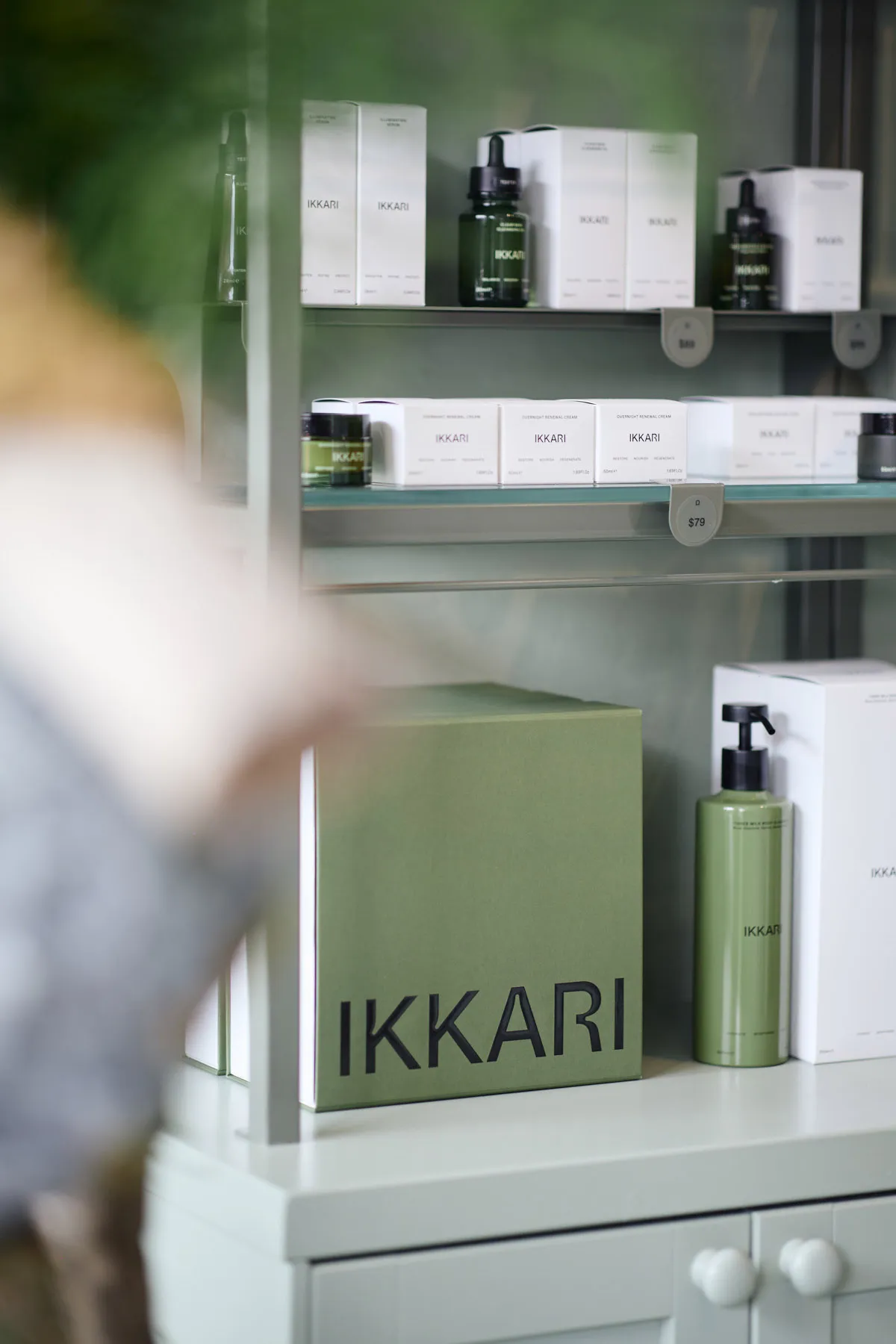Minimalist retail store display showcasing elegant green packaging products.