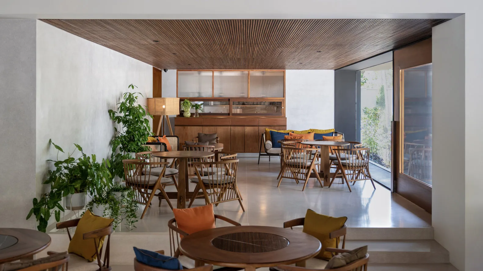 A modern cafe featuring marble and wooden furniture and design elements.