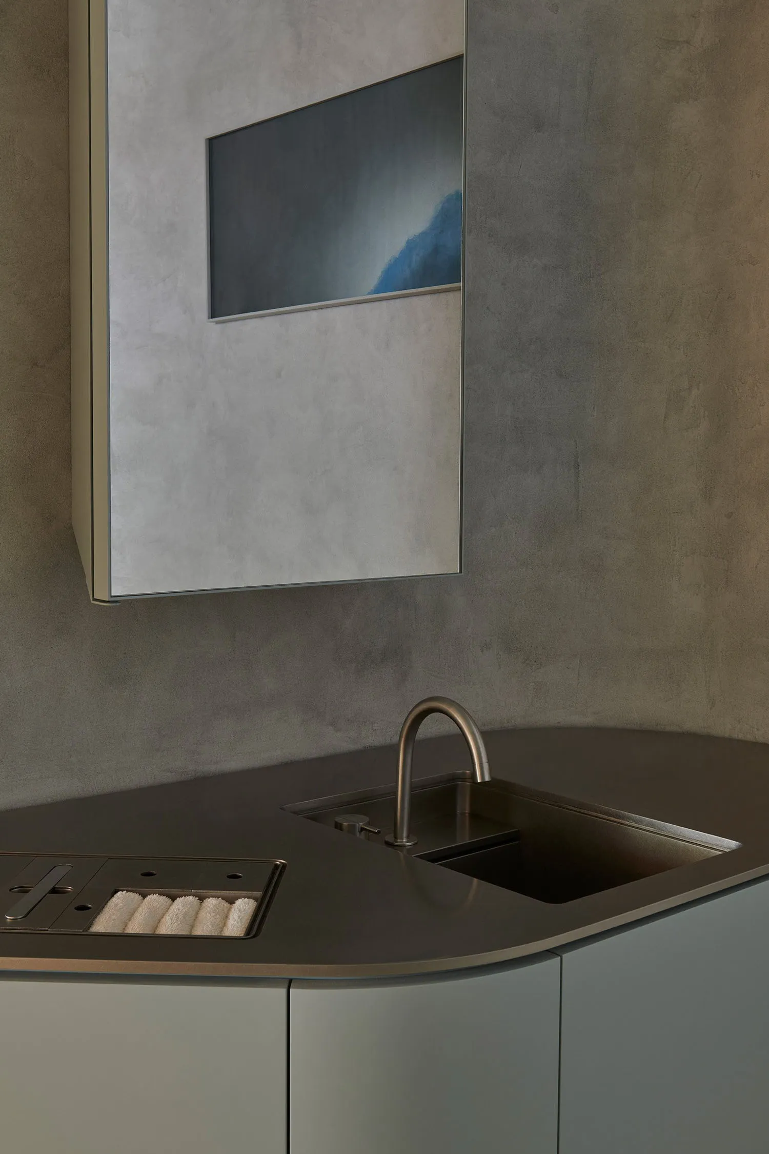 Modern kitchen featuring a concrete countertop and minimalist design.
