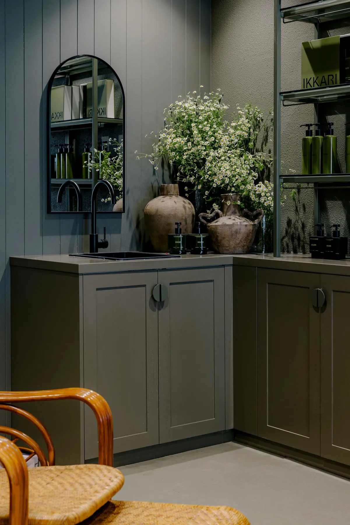 Modern kitchen featuring metallic-textured cabinets and a sink with olive green walls
