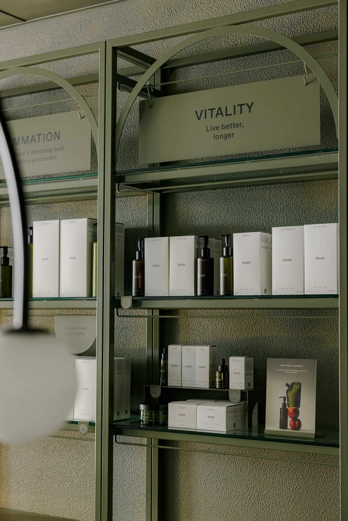 Modern, sleek product display shelf with metal framing and glass shelves.