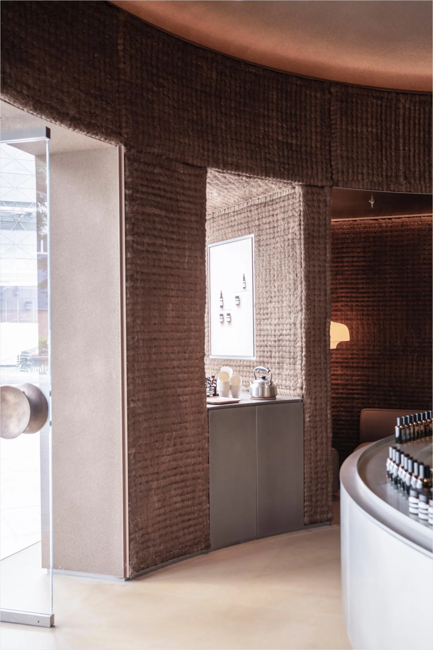 A cozy coffee shop interior with textured wall coverings.