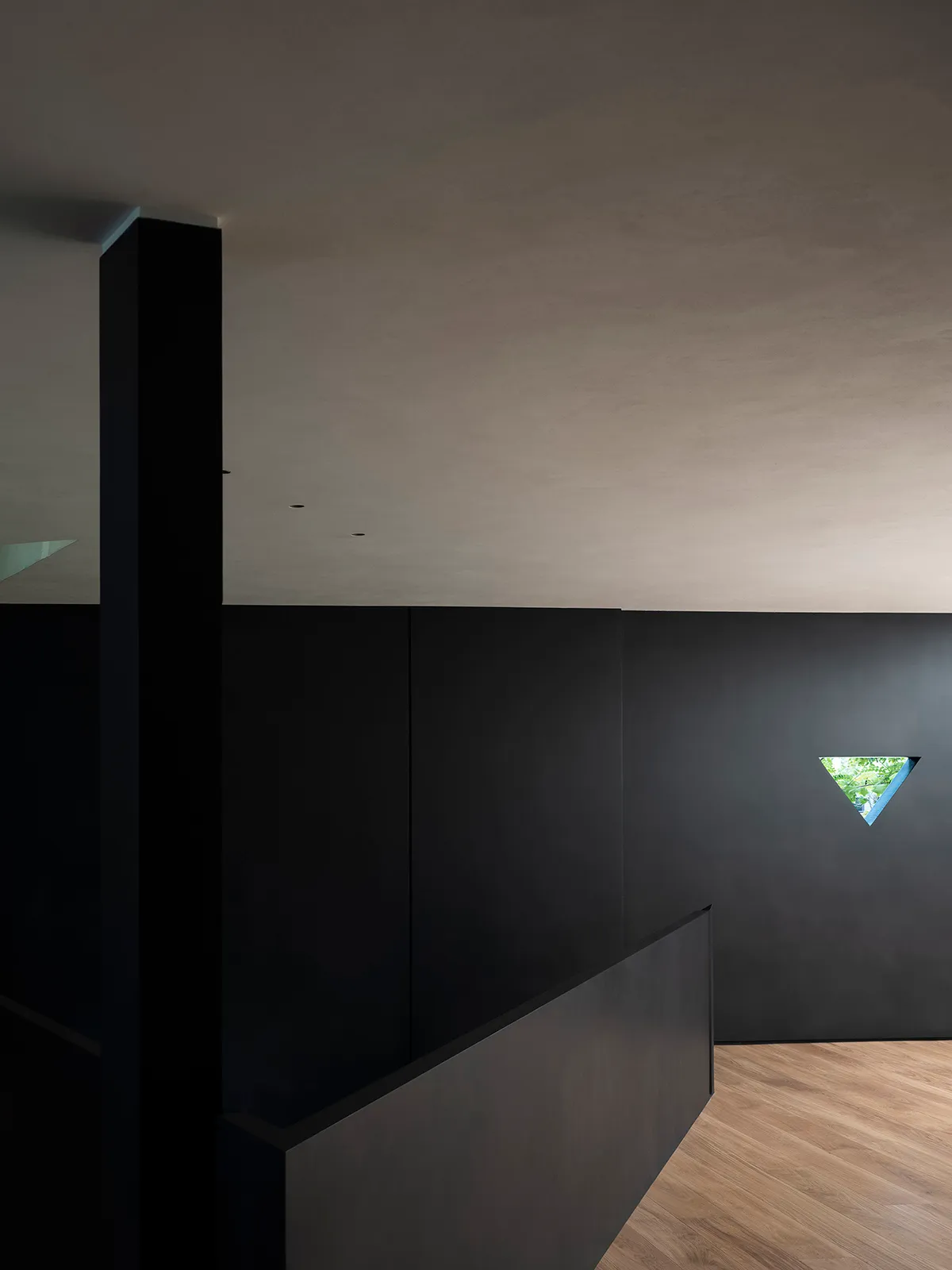 A minimalist black interior with a metallic window