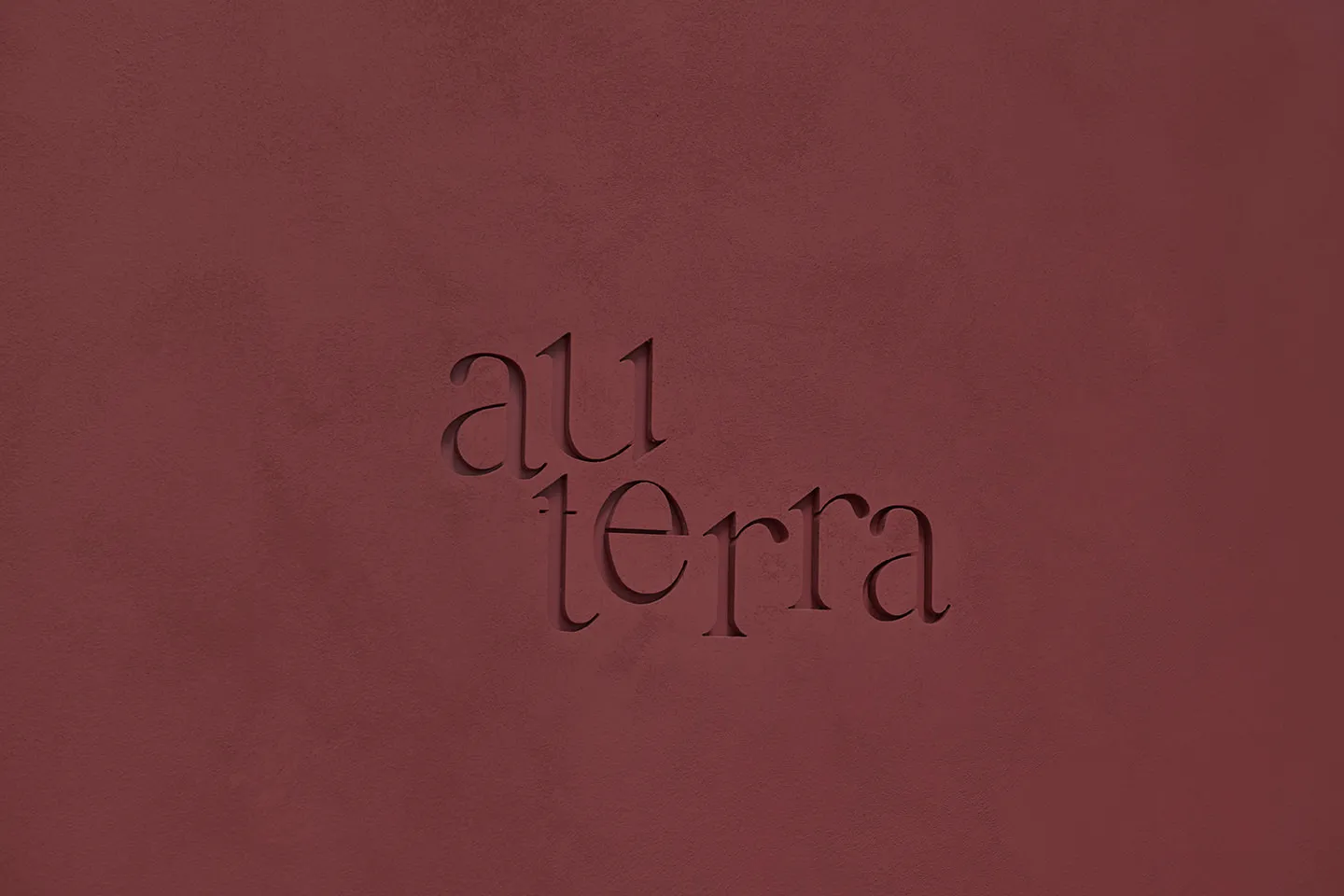 Textured surface featuring the word 'au terra' in minimalist branding design.