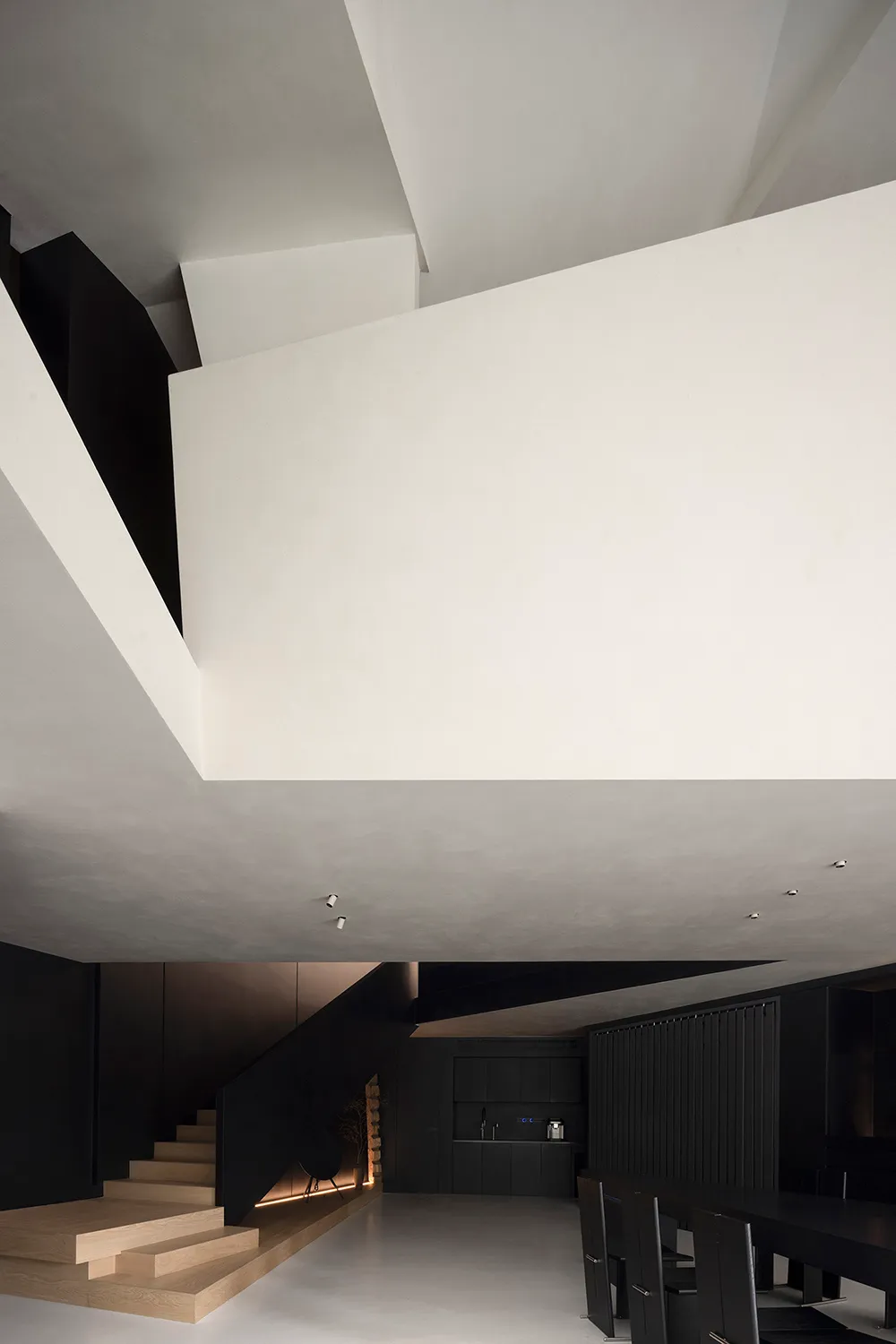 A modern interior design featuring a residential kitchen with concrete finishes.