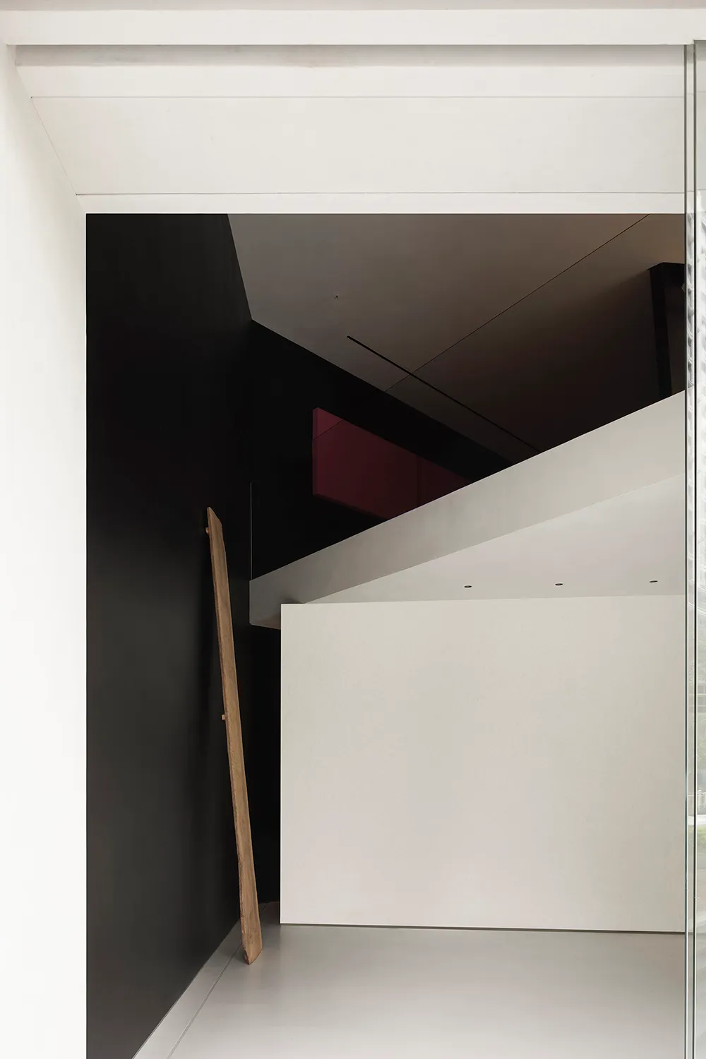 Modern minimalist interior design with white walls and open space.