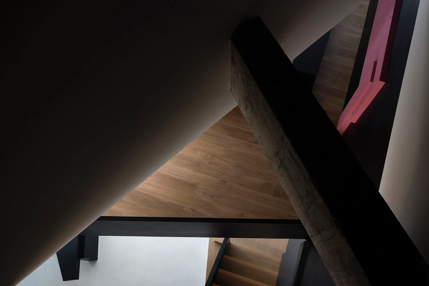 An interior space featuring modern design elements with wood, concrete, and glass materials.