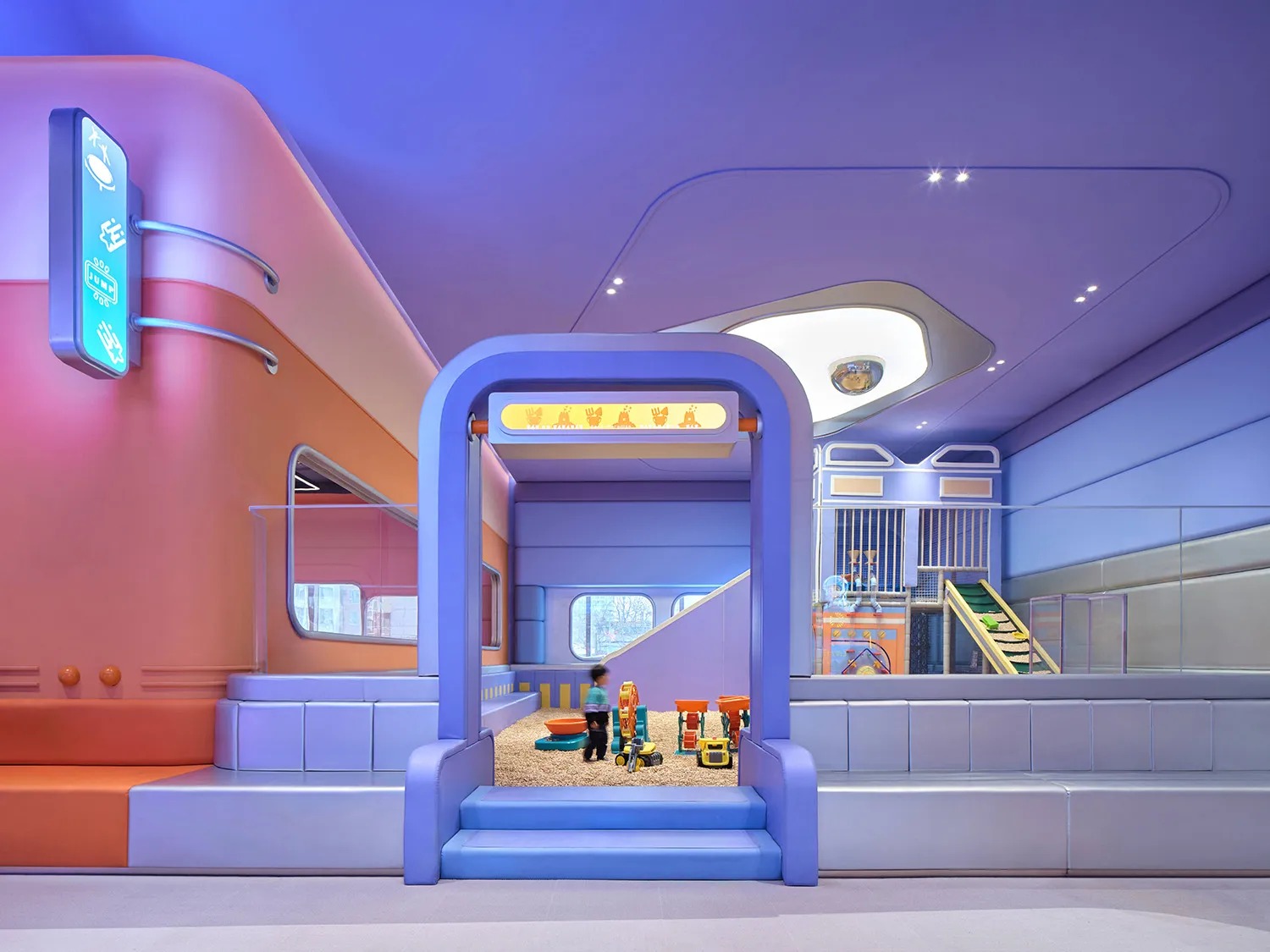 A vibrant indoor children's playground area with a variety of toys and seating