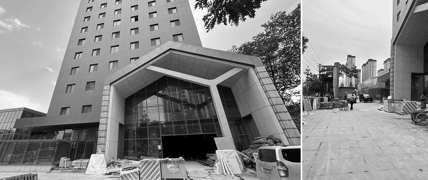 Modern entrance with glass walls and a metallic Y-shaped structure