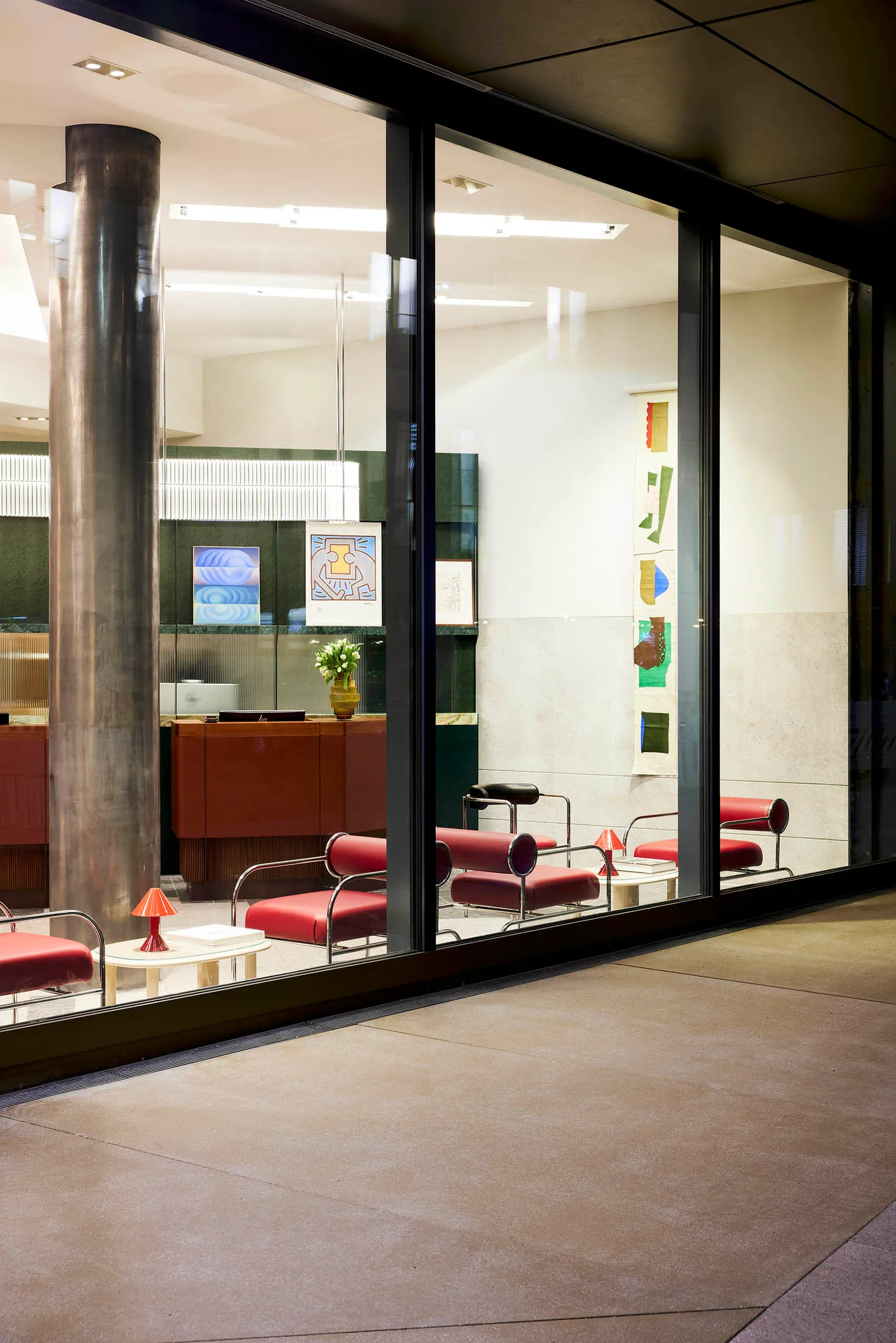 Modern lobby featuring marble, metal, and glass elements.