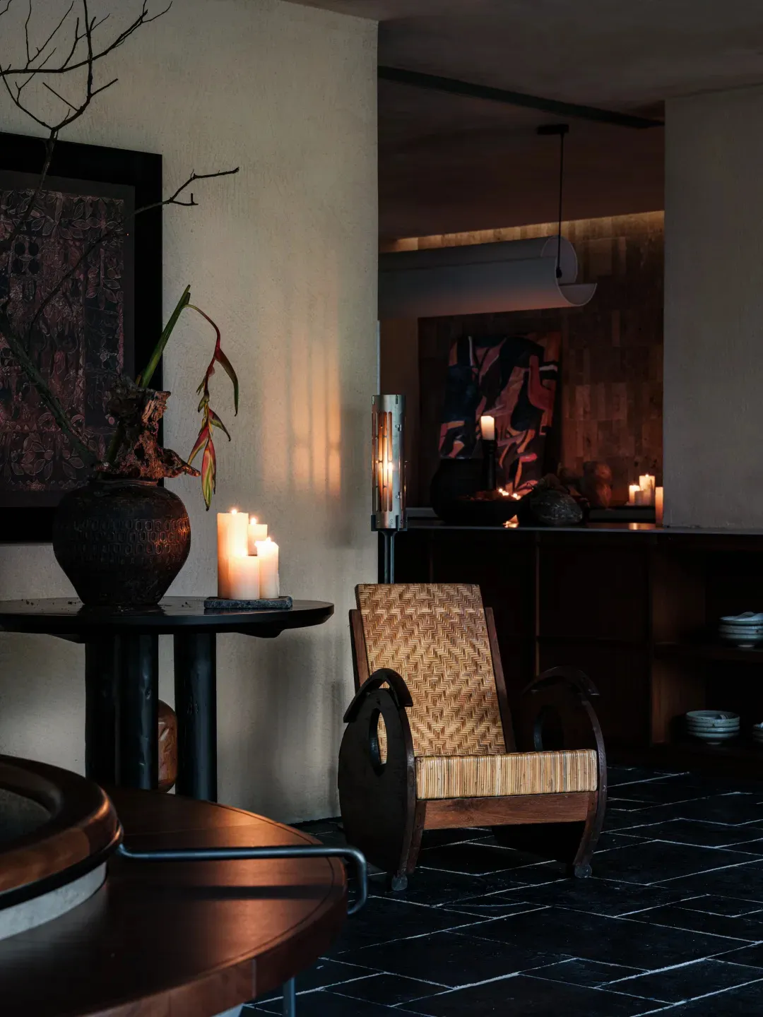 A modern residential living room featuring woven straw furniture and warm, ambient lighting.