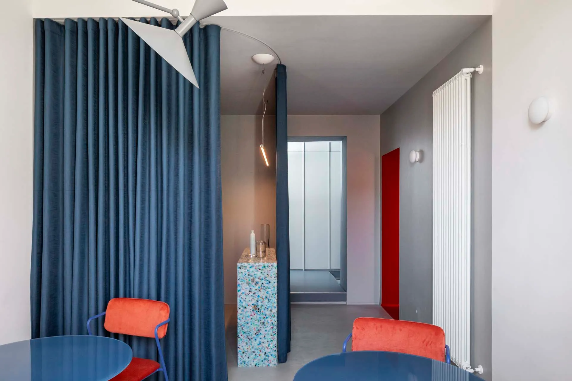 Modern dining room featuring blue fabric seating and a blue table.