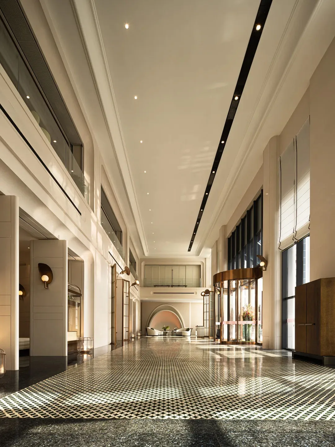 A spacious hotel lobby featuring modern lighting, concrete finishes, and glass details.