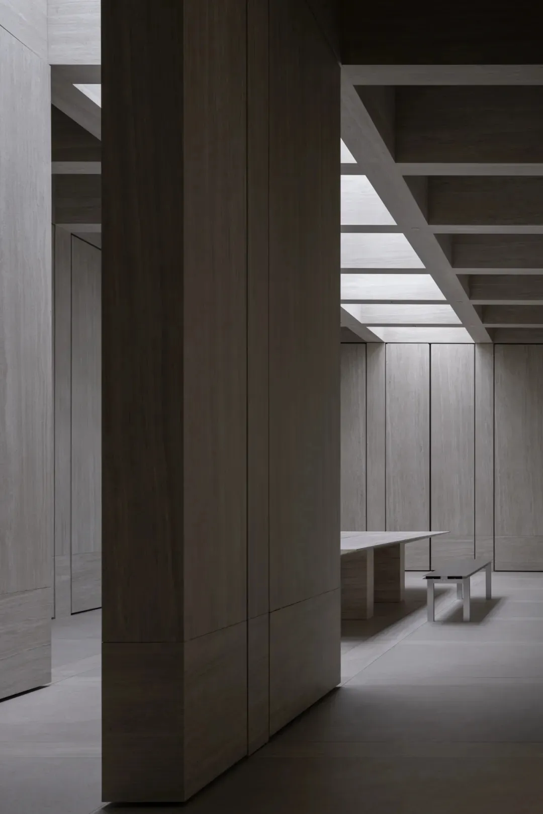 Modern office space featuring wooden panels on walls and ceiling.