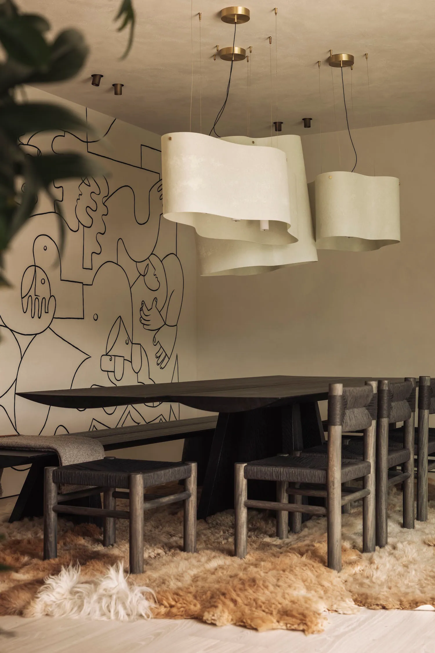 A modern dining room featuring wooden furniture, including a long dining table and chairs.