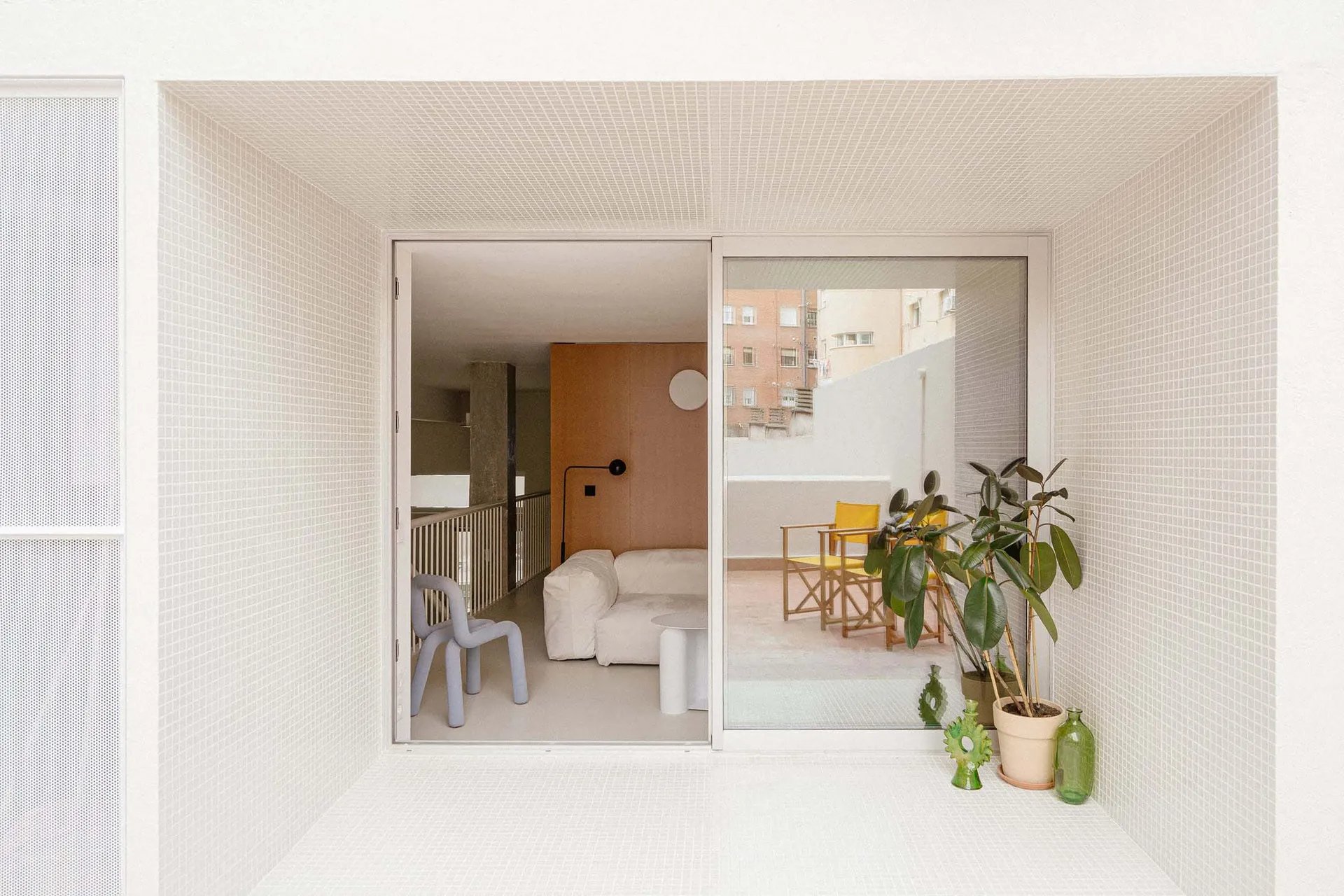 A minimalistic residential space featuring tile flooring and glass elements.