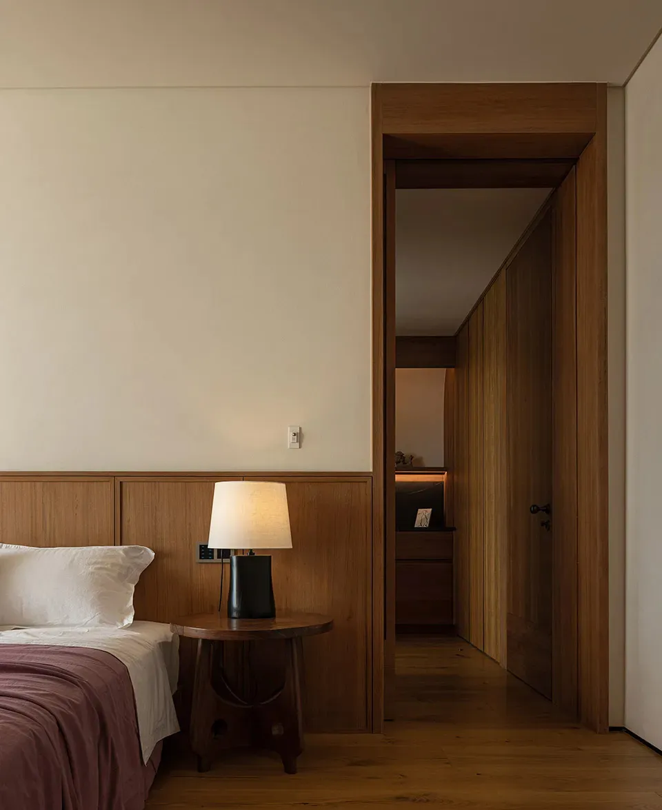 A bedroom featuring modern wood paneling and minimalist design