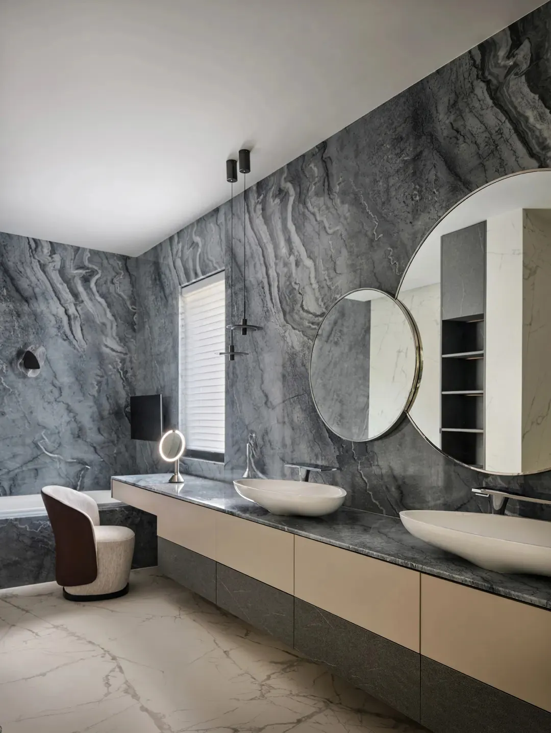 A modern bathroom featuring marble walls and a floating vanity with double sinks.