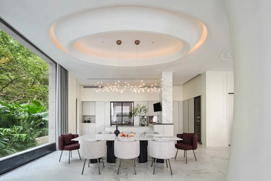 Modern minimalist dining room with a white marble table and chairs