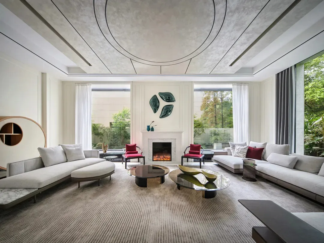 A minimalist living room with neutral-toned furniture and a modern fireplace.