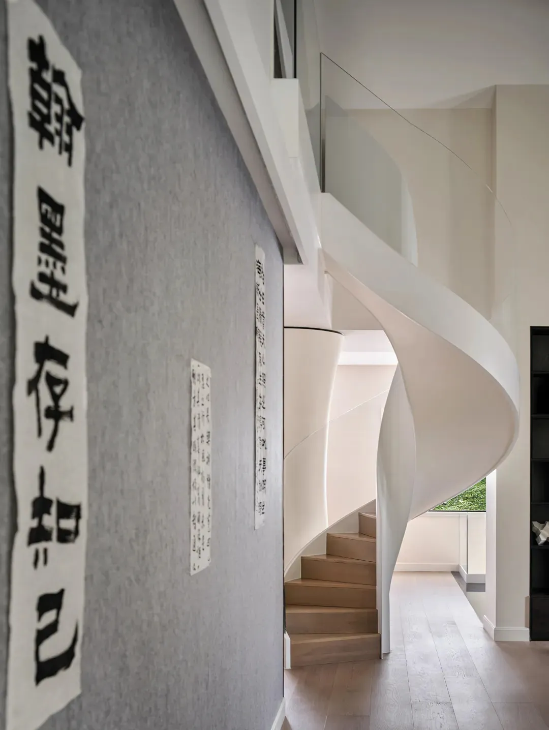 A modern staircase with wooden steps and white railings.