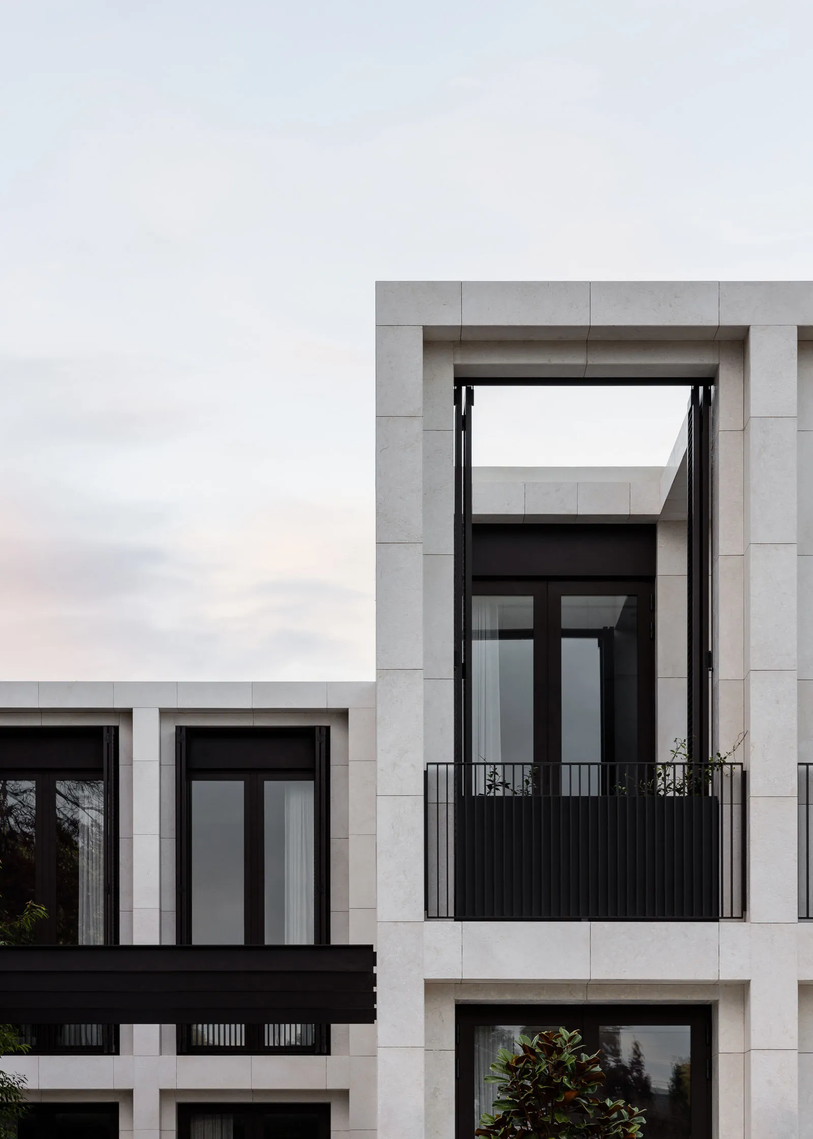 Modern residential mansion featuring minimalist architecture with white marble exterior.