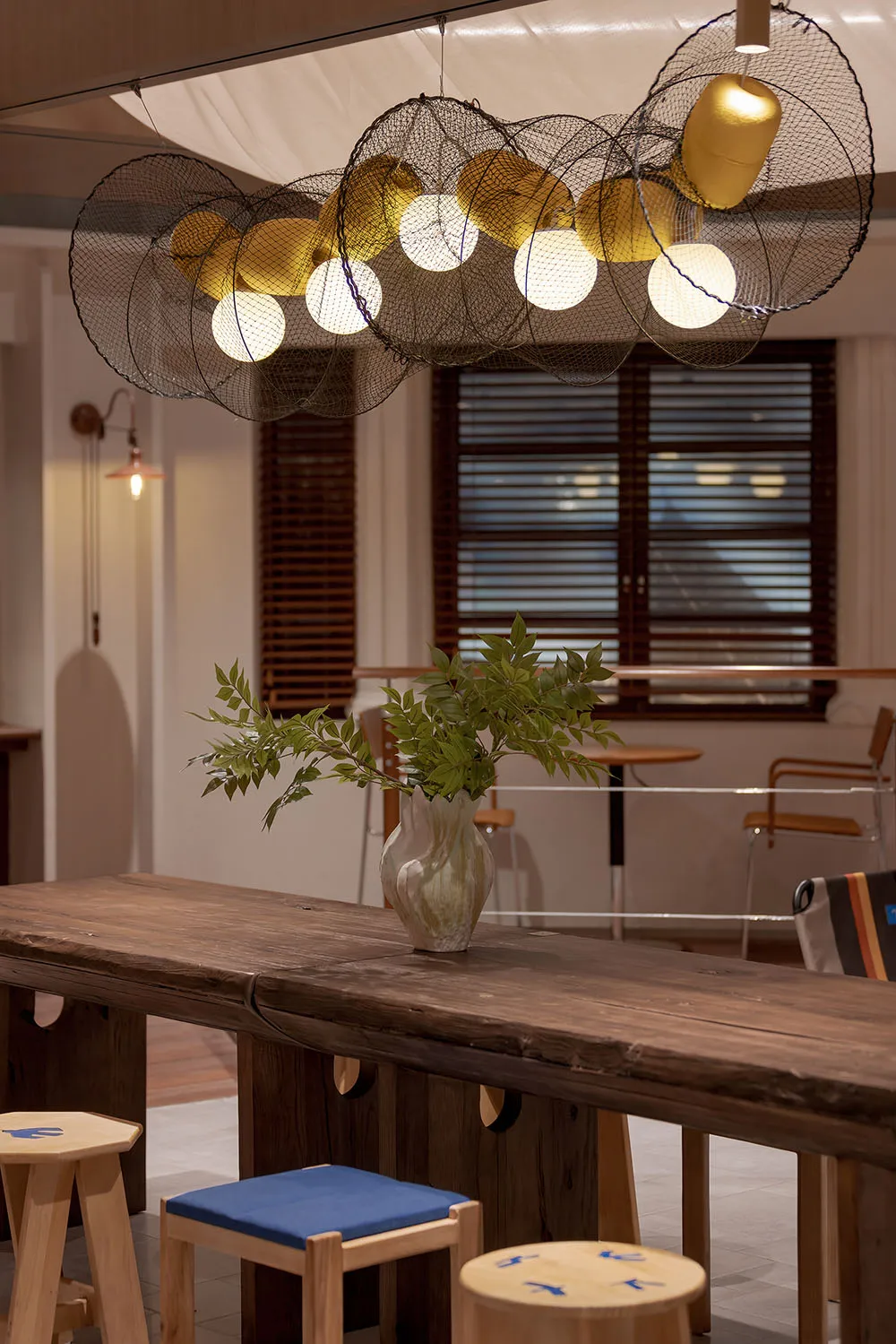 A modern interior featuring wooden furniture, metallic accents, and glass elements.